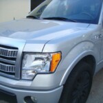Before and after photographs of a damaged Ford pickup truck that was repaired by Elite Paint & Body Shop in West Palm Beach, Florida.
